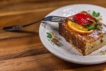 Strawberry-Lemon Fruit Cake on Dish with fork on wooden table