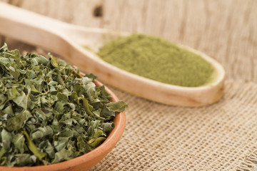Dust and moringa leaves on wooden background
