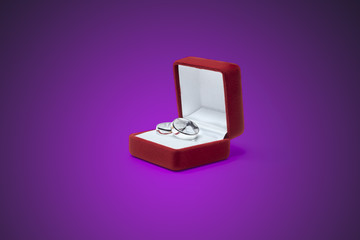 wedding rings and jewelry box on a wooden table