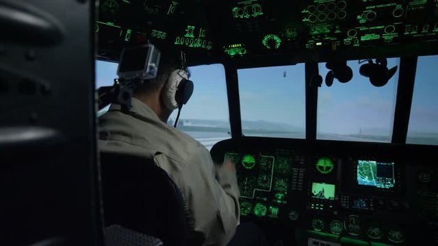 Pilots in Helicopter Cockpit Simulator by Instrument Panel