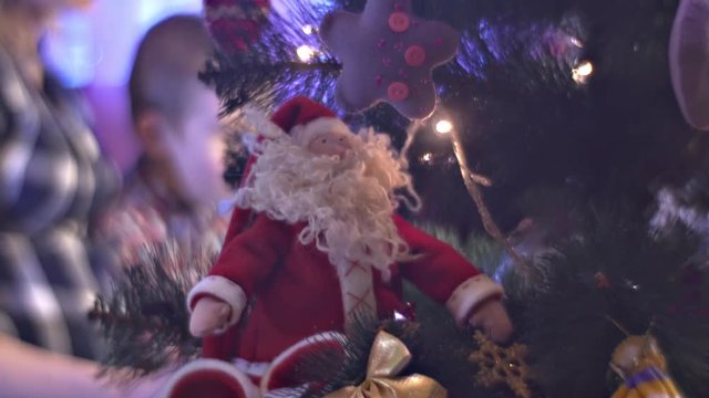 Pregnant Mom is Reading Book to Son Turns Page Happy Family Sitting Ner Decorated New Year Tree and Spends the Evening Together Holidays at Home