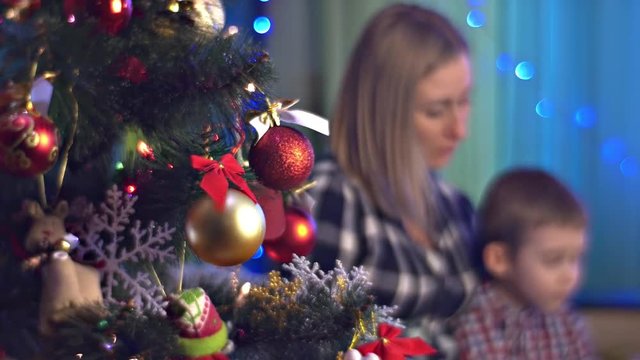 Blurred Image of Mom and Son Are Reading Christmas Holidays Together New Year Tree Pregnant Mom Gives Education to Her Kid Spends Time With Him Teaching