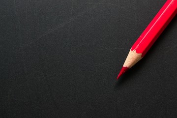 The pencil red on black background / Business concept