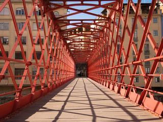 Red iron Eiffel bridge in Girona
