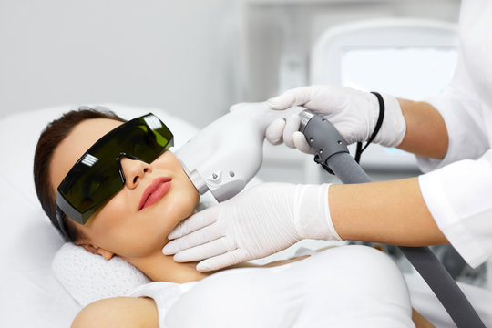 Woman Receiving Laser Hair Removal Procedure At Beauty Salon