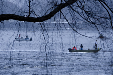 Moody cold scene of fishermen fishing from boats on Wisconsin river