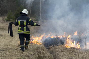 Obraz premium A spring fire. Burning grass. Field Smoke Background