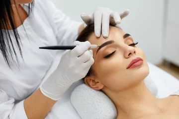 Peel and stick wallpaper Beauty salon Beautician Doing Permanent Eyebrows Makeup Tattoo On Woman Face