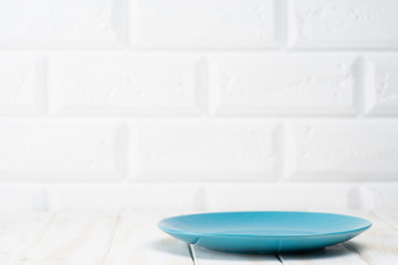 Naklejka na ściany i meble Blue plate on the kitchen table