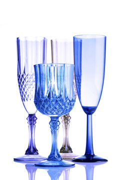 colored glasses of varying shape and size on a white background