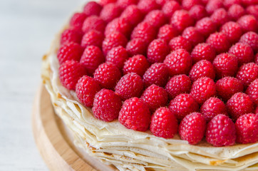 Pancake cake with condensed milk cream and raspberries