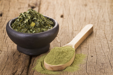 Dust and moringa leaves on wooden background
