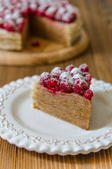 Pancake cake with condensed milk cream and raspberries
