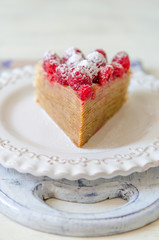Pancake cake with condensed milk cream and raspberries
