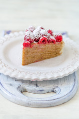 Pancake cake with condensed milk cream and raspberries