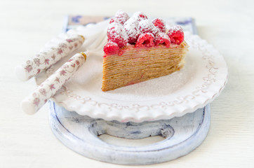 Pancake cake with condensed milk cream and raspberries
