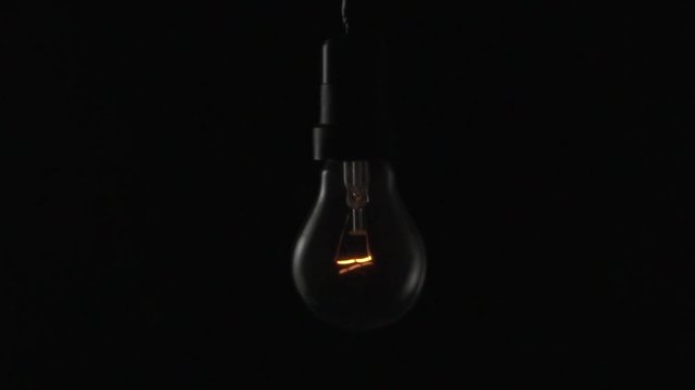 Light bulb swinging. Slow motion.