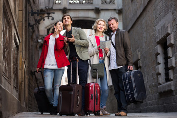 Portrait of tourists with map and baggage seeing the sights in European city