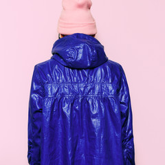 Hipster model in bright jacket and hat Urban style