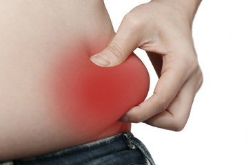 woman measuring her belly fat with her hands