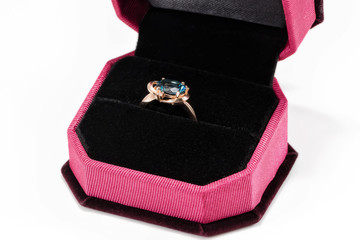 Gold ring with blue Topaz in a velvet gift box