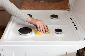  Housewife  hand with a rag clean the dirty gas stove