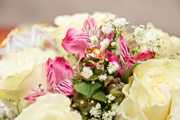 The rings on the flowers, in a box, on a white fabric on toys, colors, wedding details, wedding rings