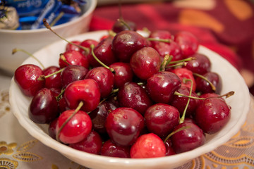 A plate of red ripe cherries bright colors, summer