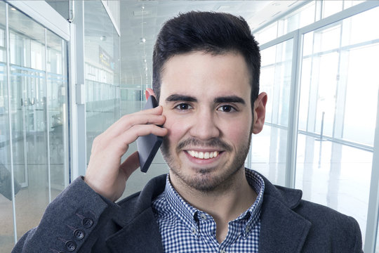 businessman smiling talking on mobile phone