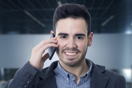 businessman smiling talking on mobile phone
