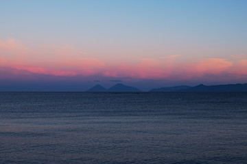 Sunset at the Tyrrhenian Sea. Islands on the horizon. Marina di Patti. Sicily
