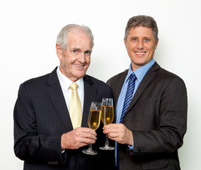 Successful men drinking champagne at office party