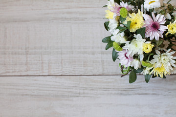Bouquet of different chrysanthemums on wooden background. Aerial view. Copy space