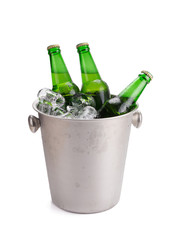 cold bottles of beer in bucket with ice on white background.