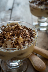 Tiramisu in glass. Italian dessert. Beautiful wooden background.