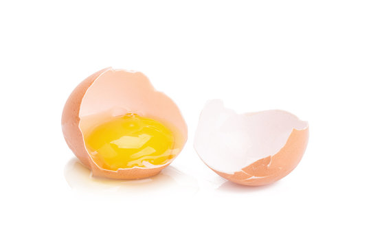 Close up of cracked egg on white background.
