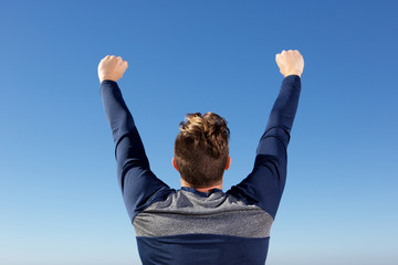 behind of man with harsh raised in the air