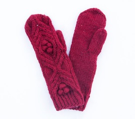 Red knitted woolen mittens with ornament
