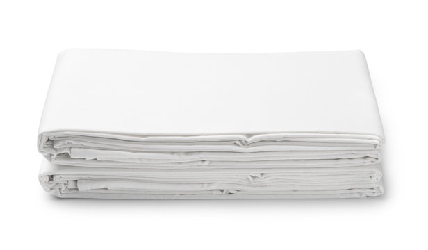 Stack of white folded bedding sheets