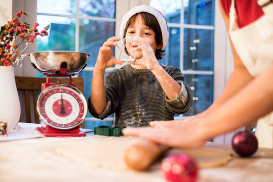 Mother and son making Christmas cookies at home