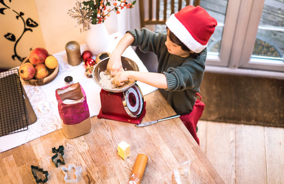 Boy weighing flour in scale