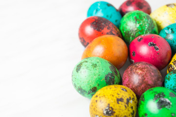 Color quail eggs on the white background