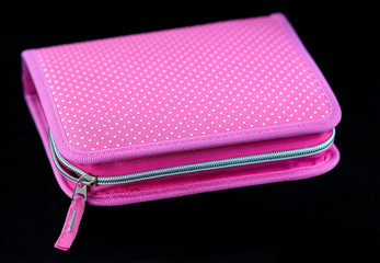 Pink pencil case on a black background