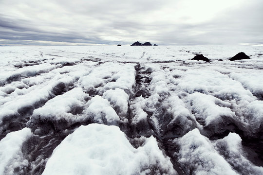 Frozen snow covered landscape and distant mountains, Iceland