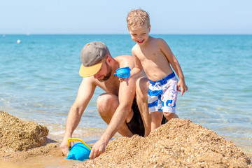 Dad and little son playing together