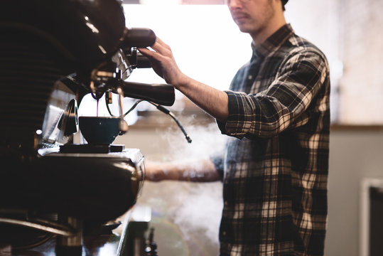 Barista preparing coffee in cafe