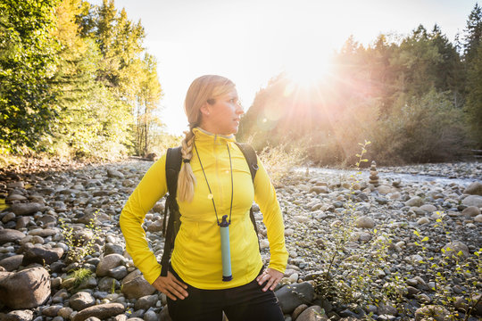 Female hiker looking from riverbed in Englishman River Falls Provincial Park , Vancouver Island, British Columbia, Canada