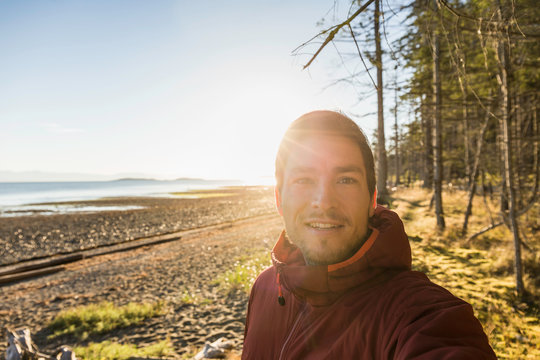 Sunlit portrait of man at Rathrevor Beach Provincial Park, Vancouver Island, British Columbia, Canada