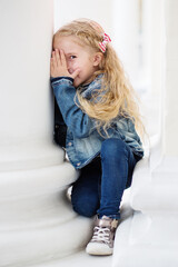 Fototapeta premium Happy little girl playing peekaboo