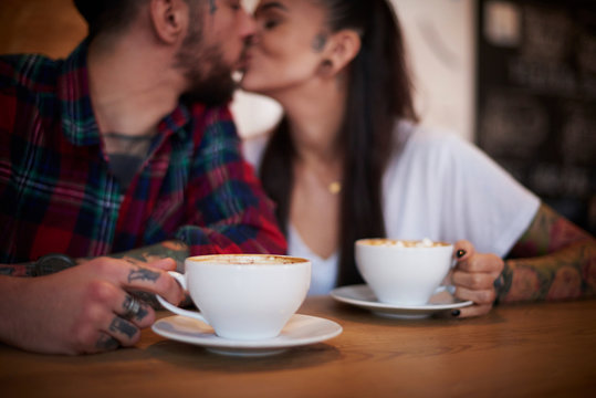 Couple kissing in cafe